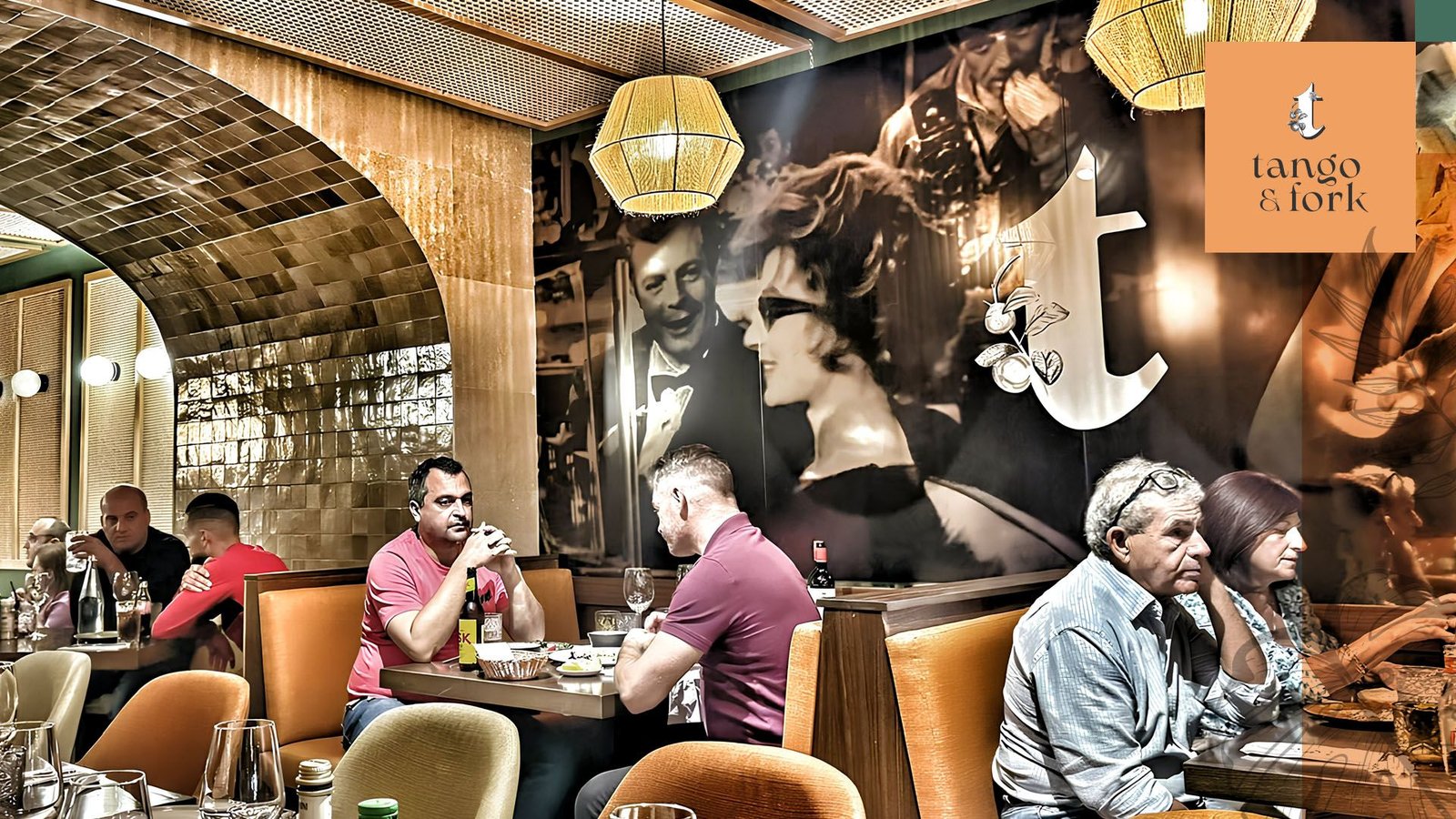 Guests dining inside Tango & Fork restaurant with warm lighting and stylish interior design