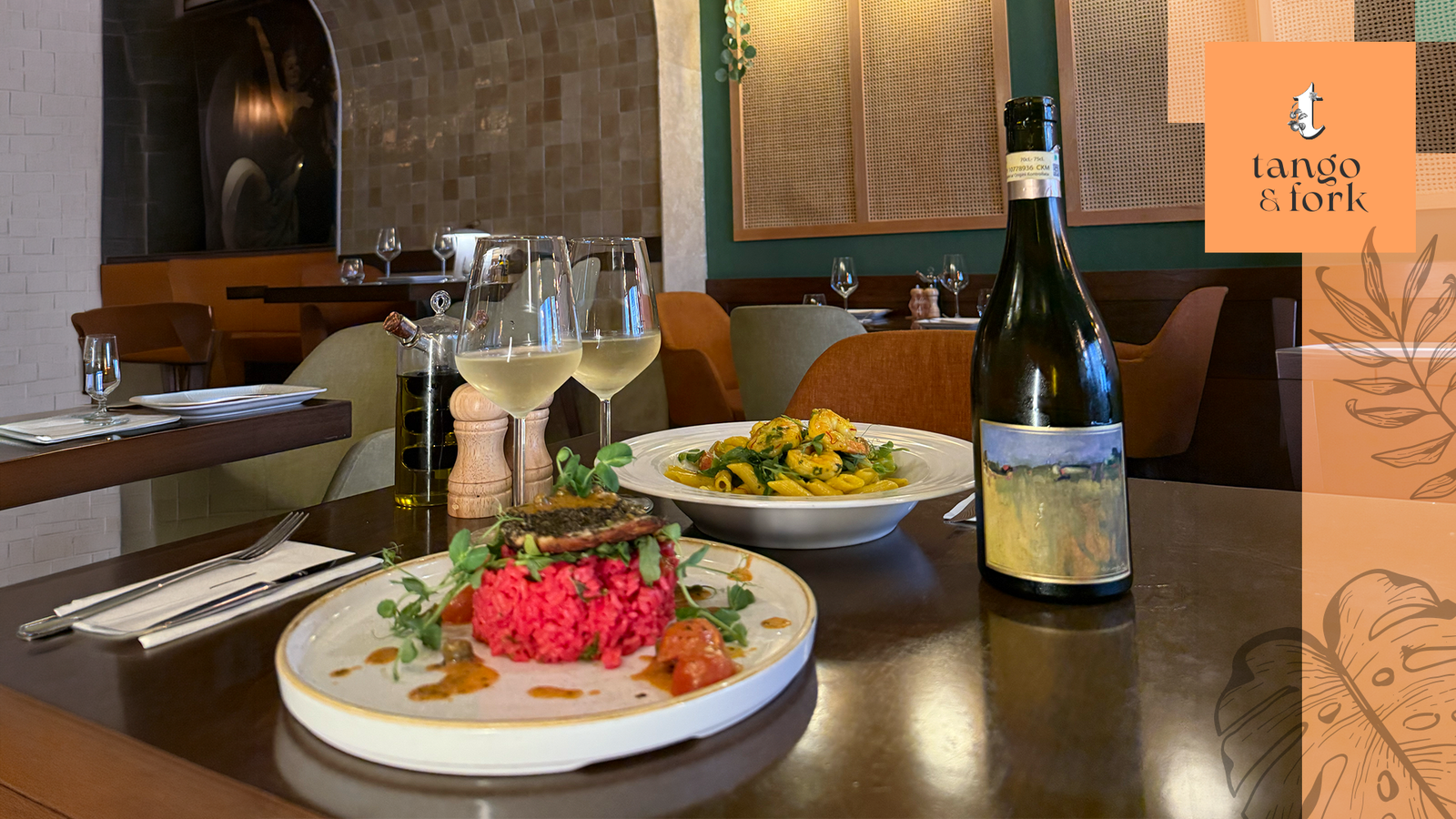Herb crusted lamb dish with fresh salad and white wine at Tango & Fork restaurant interior